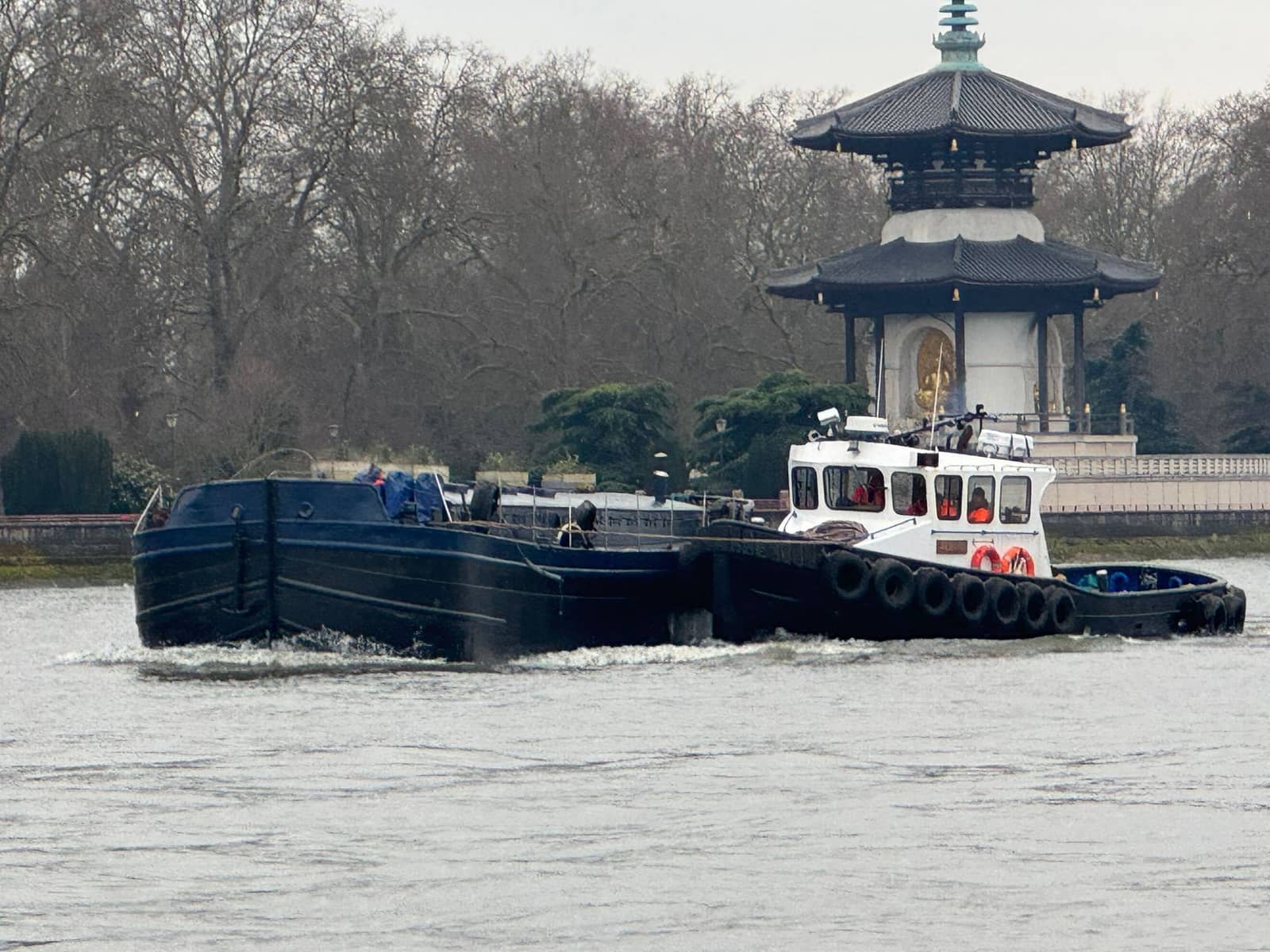 MMS workboat tug Felaura towing a barge past Battersea on the River Thames