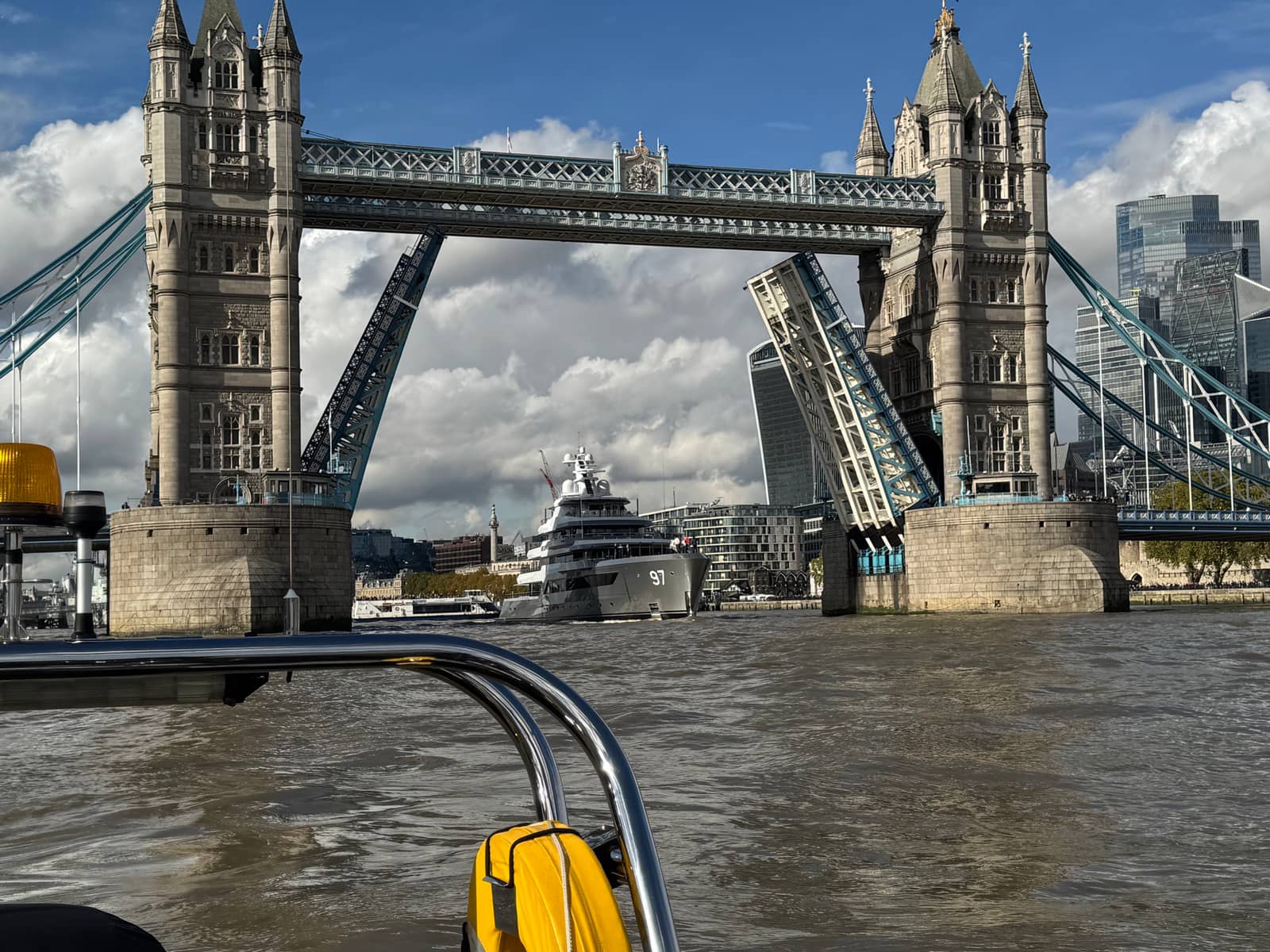 MMS workboat passing a raised Tower Bridge on the River Thames